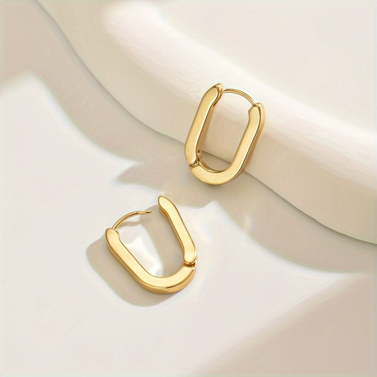 Rectangle hoop earrings in gold, worn