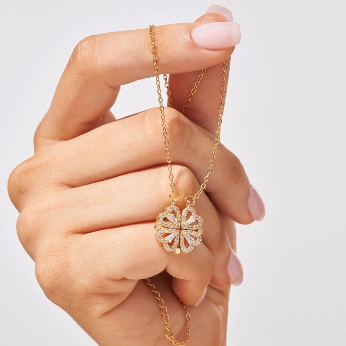 Close-up of the four heart clover pendant in the hand