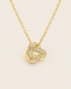 Love knot necklace in gold, close view of the knot
