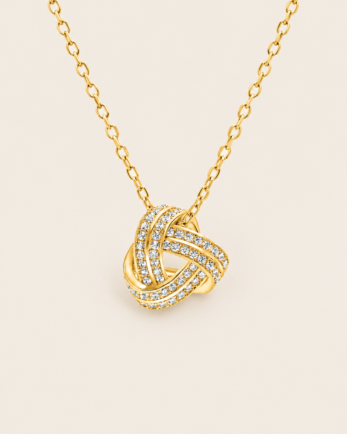 Love knot necklace in gold, close view of the knot